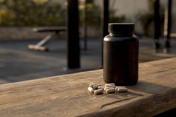 Magnesium supplement capsules spilled on gym counter