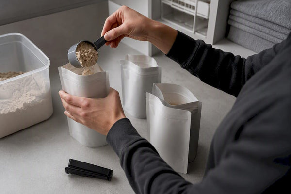 Hands portioning protein powder for storage