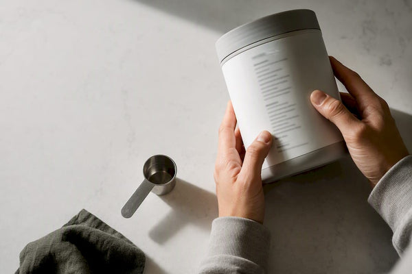 Hands inspecting an anonymous supplement label