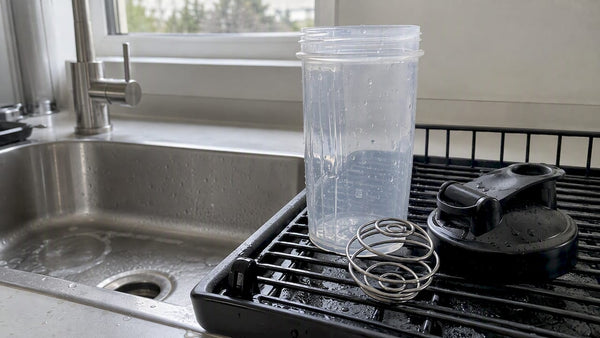 Shaker bottle parts drying separately on a rack