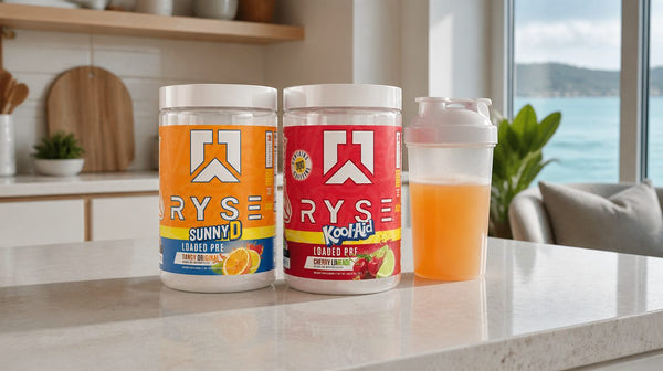 Ryse Loaded Pre SunnyD and Kool-Aid Cherry Lemonade tubs on a kitchen bench beside a shaker of orange drink