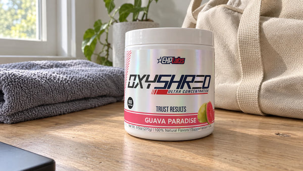 EHPlabs OxyShred Guava Paradise tub beside a gym bag and towel