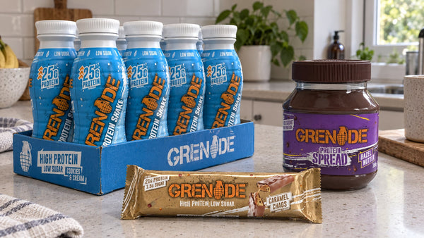 Grenade Caramel Chaos bar, Cookies and Cream protein shakes and Hazel Nutter spread on a kitchen bench