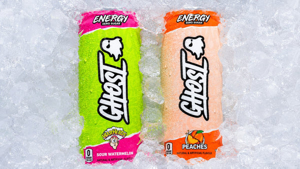 Two zero-sugar Ghost Energy cans, Sour Watermelon and Peaches, chilling on ice