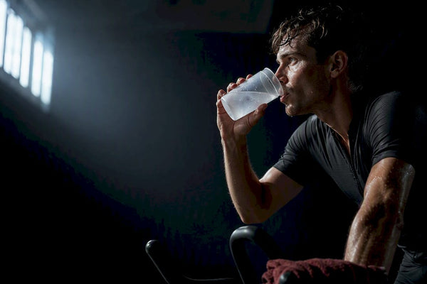 Athlete drinking carbohydrate drink during training