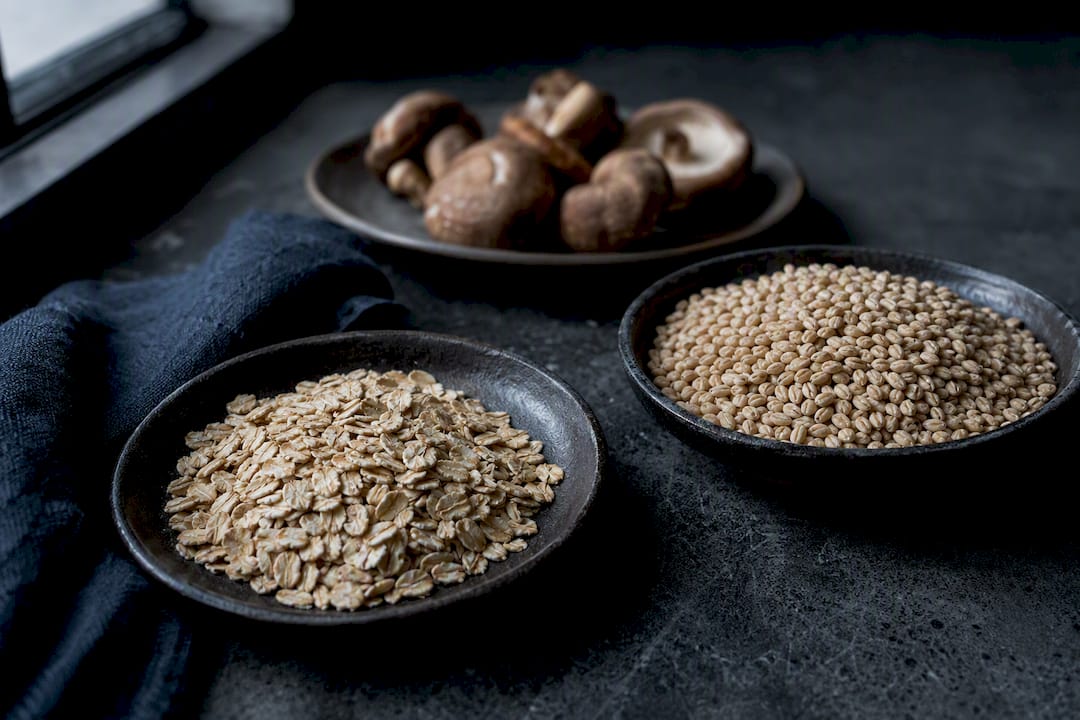 Oats barley and mushrooms representing beta glucan sources