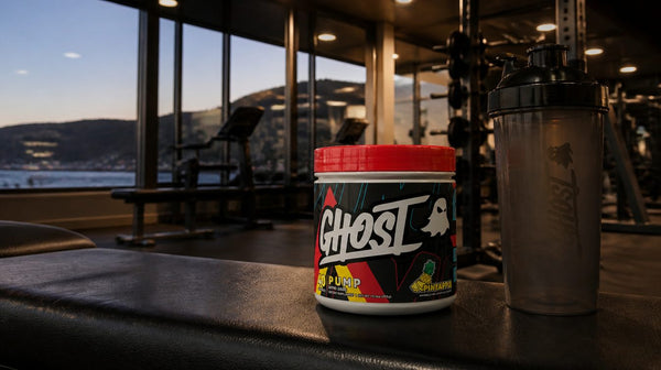 Ghost Pump V2 Pineapple tub on a gym bench beside a shaker in an evening gym