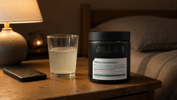 Pillar Performance Triple Magnesium Lemon Lime beside a bedtime drink and face-down phone