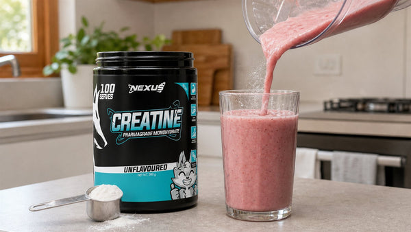 Nexus Creatine Monohydrate powder and scoop beside a fruit smoothie being poured