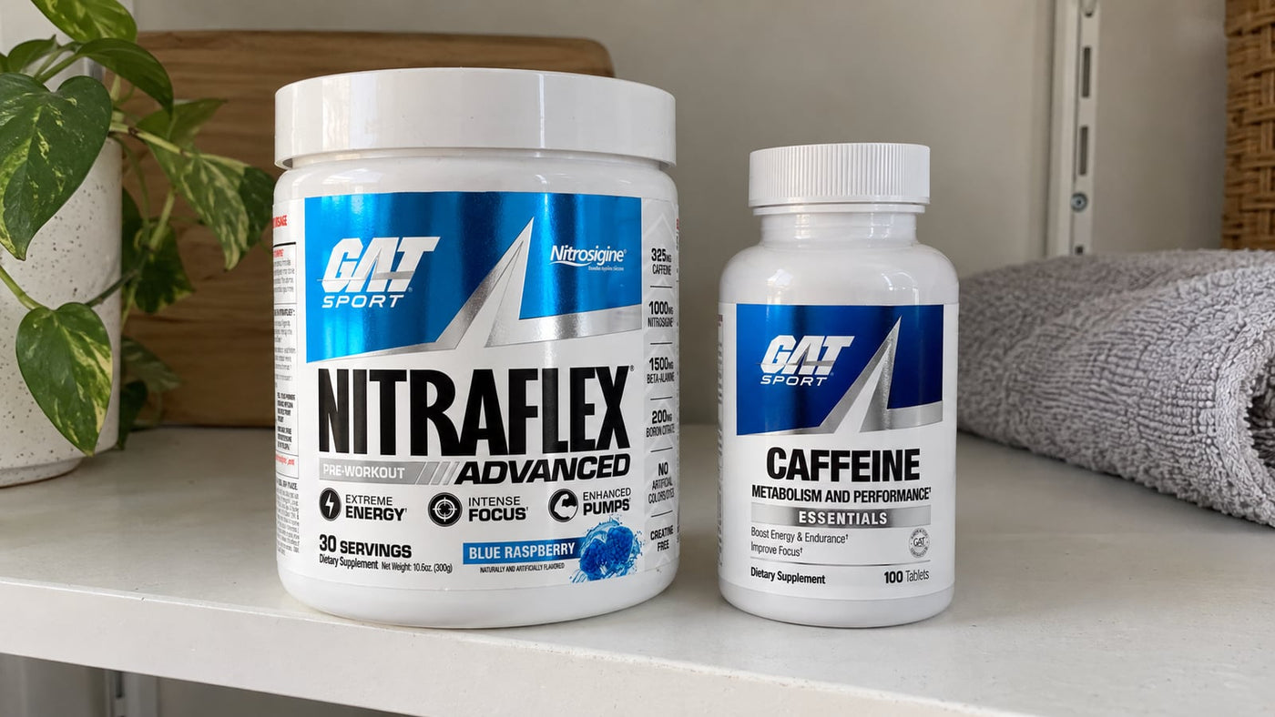 GAT Nitraflex Advanced Blue Raspberry tub and Essentials Caffeine bottle on a shelf