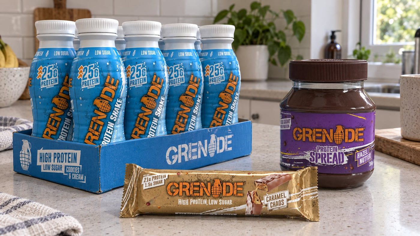 Grenade Caramel Chaos bar, Cookies and Cream protein shakes and Hazel Nutter spread on a kitchen bench