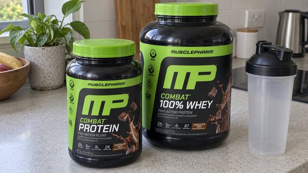 MusclePharm Combat 100% Whey and Combat Protein chocolate tubs in a home setting