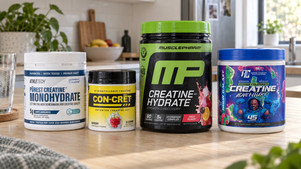Athletech monohydrate, Con-Cret Raspberry HCl, MusclePharm Creatine-Hydrate and Ronnie Coleman Sour Galaxy creatine on a kitchen island.