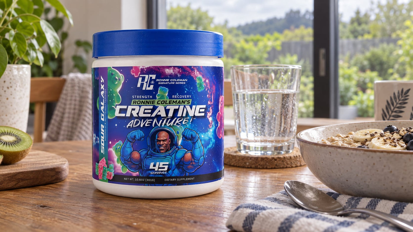 Ronnie Coleman Creatine Adventure Sour Galaxy beside oats and water at a breakfast table.