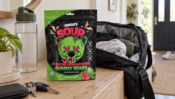 Swoleys Sour Watermelon Creatine Gummy Bears beside an overnight bag and water bottle.