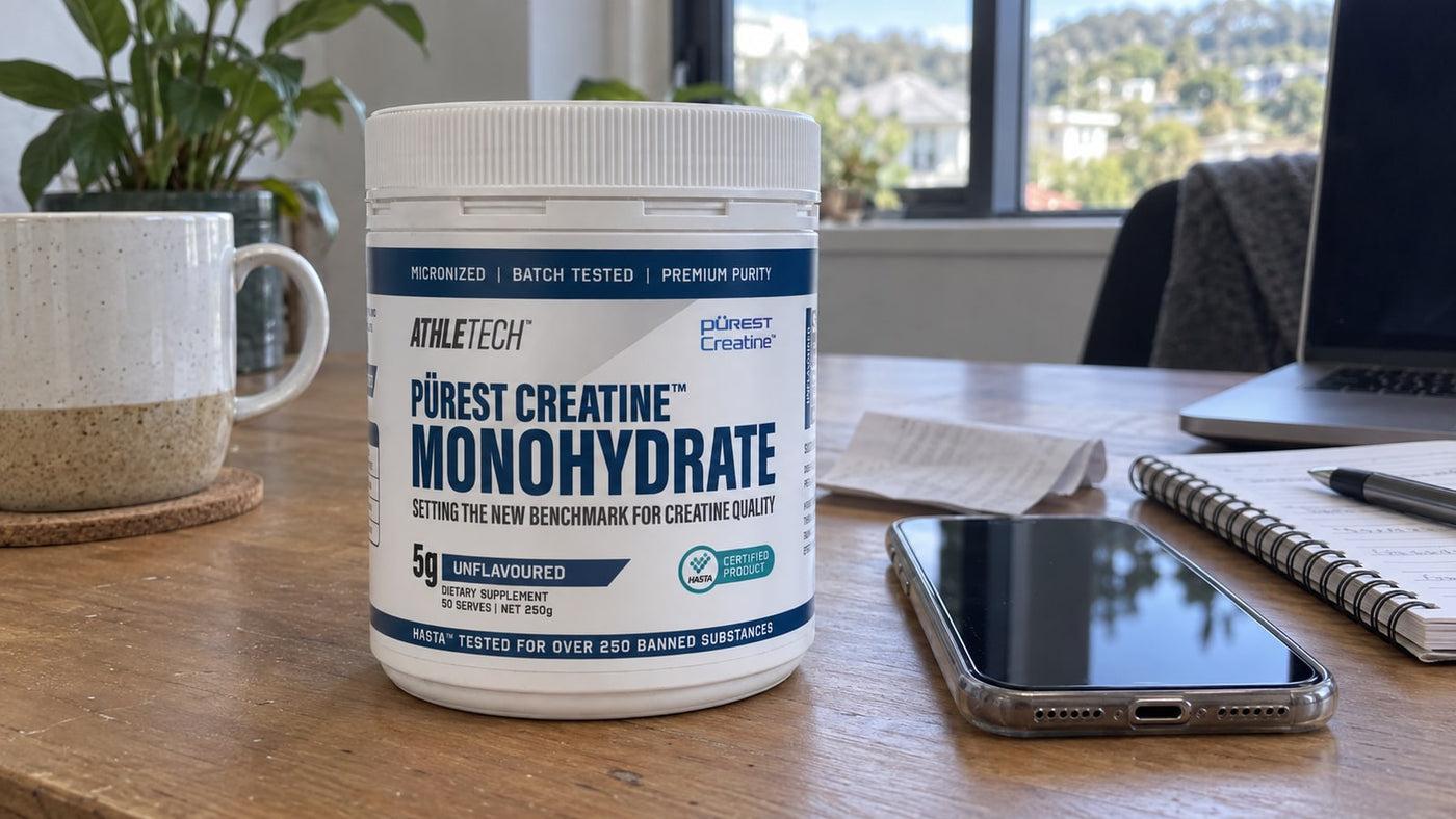 Athletech Purest Creatine Monohydrate beside a phone, receipt and notebook.